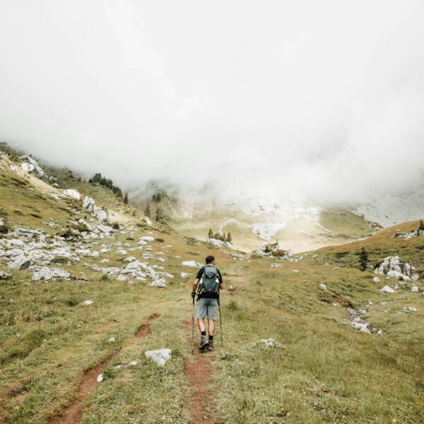 A person carrying a bag hiking.